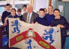 Maybole Community Council chairman David Kiltie hows xl club members the Carrick Academy flag made by pupils in 1954